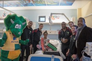 Patient Gercia and dad Gervais with Left to Right: Sporty Lewis Grabban Gary ONeil Cameron Jerome Steven Whittaker and Matt Jarvis