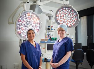 Two anaesthetists standing in a hospital theatre