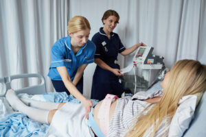 Two midwives carrying out an antenatal scan