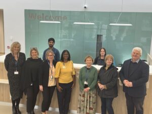 A line up of members of the executive team and radiology team in front of the CDC reception desk