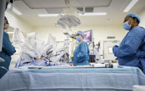 Staff wearing face marks in theatre with the surgical robot