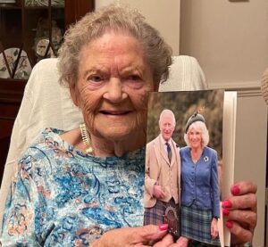 Annetta Lord holding her 100th birthday card from the King and Queen