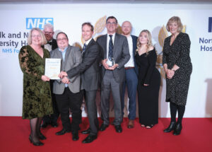 The Norwich Hand Unit team holding their winning trophy and certificate