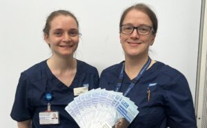 Two Recognise and Respond Team members holding Martha's Rule leaflets